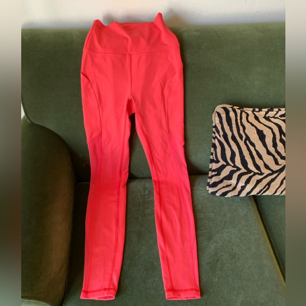 NEVER WORN. Lululemon size 4 electric orange/red/coral pants